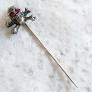   cross bones stick pin from the early part of the 20th century red gem