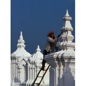  Temple Worker Applies Coat of Whitewash to 14th Century 