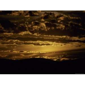 Sunset Illuminates Dappled Storm Clouds over a Mountain Top, Australia 