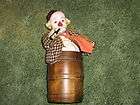 beautiful musical clown in a barrel with a wine bottle