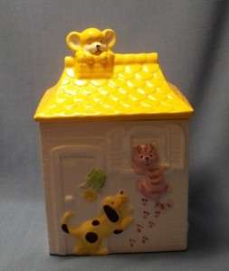 DOG, CAT, AND MOUSE ON A HOUSE COOKIE JAR. YELLOW AND PINK COLORS 