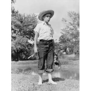 Boy Wearing Straw Hat and Holding a Fishing Rod, Standing Barefoot By 